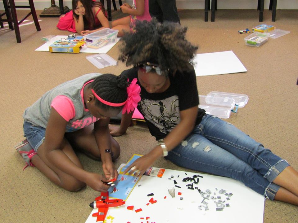 Two children coloring on the floor