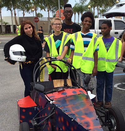 A team poses with their box race car