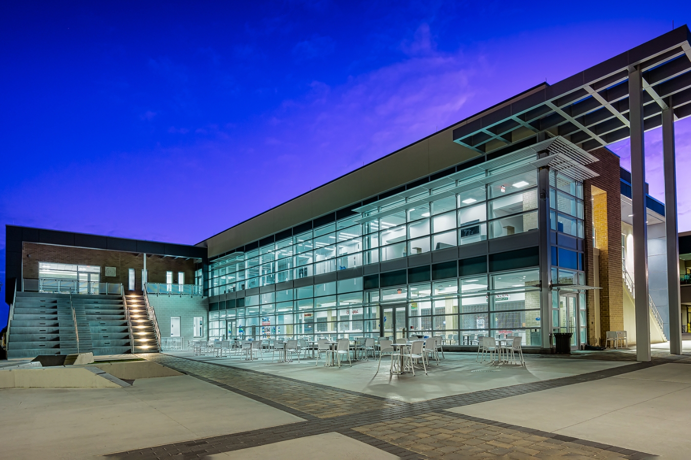 A wide shot of the Student Union (Bldg. 16) on the Melbourne Campus at night with a clear view of the food court and conference rooms inside.