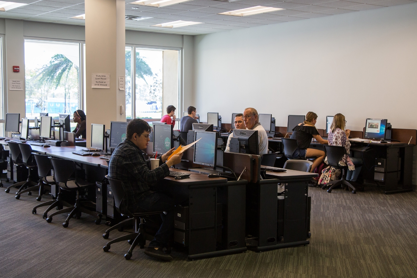 Students utilizing accessible computer spaces in the library as part of an inclusive learning environment designed to foster success and growth