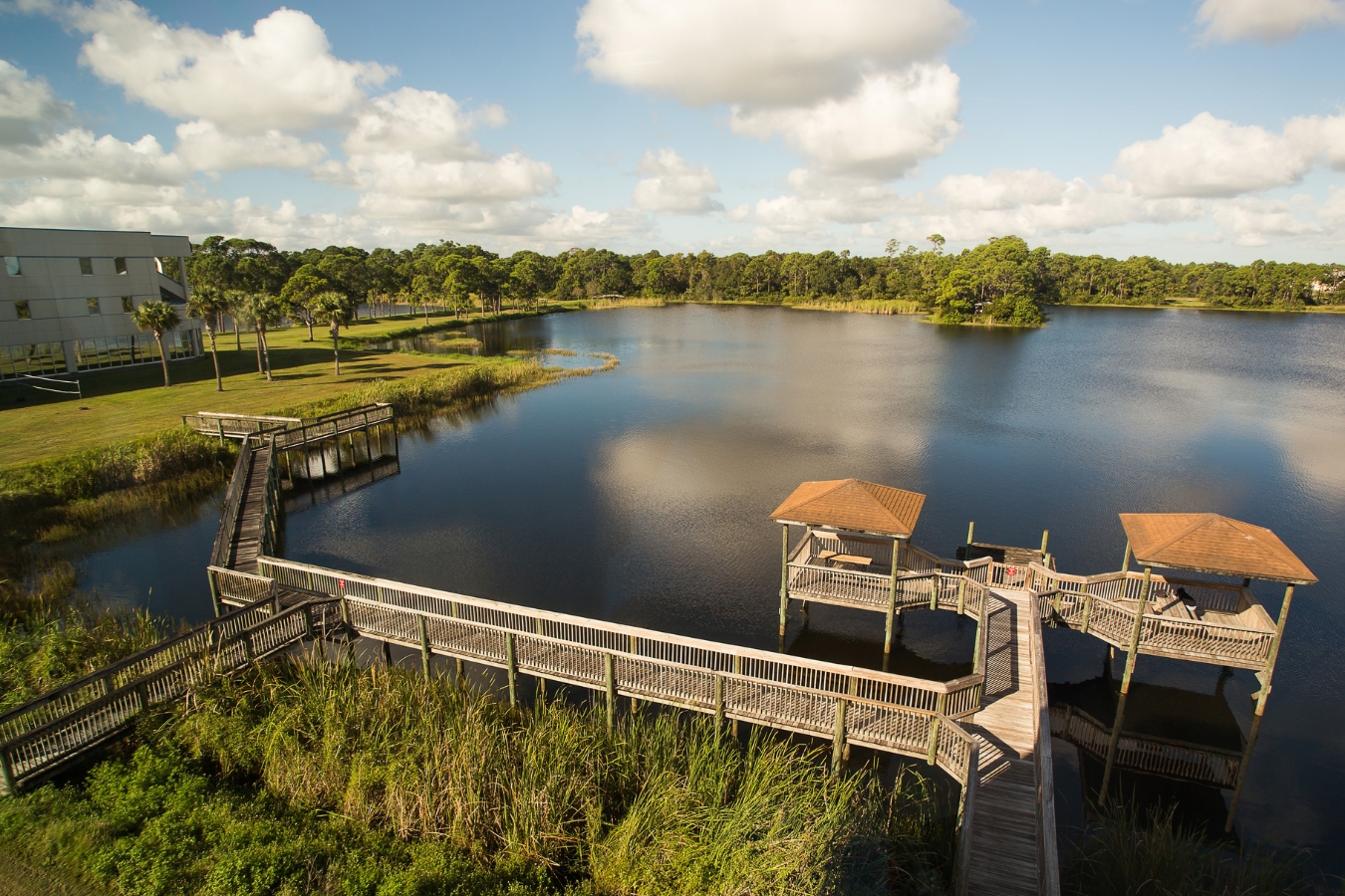 Scenic view of the Palm Bay campus with Lake Titan and its nature board walk in the foreground.