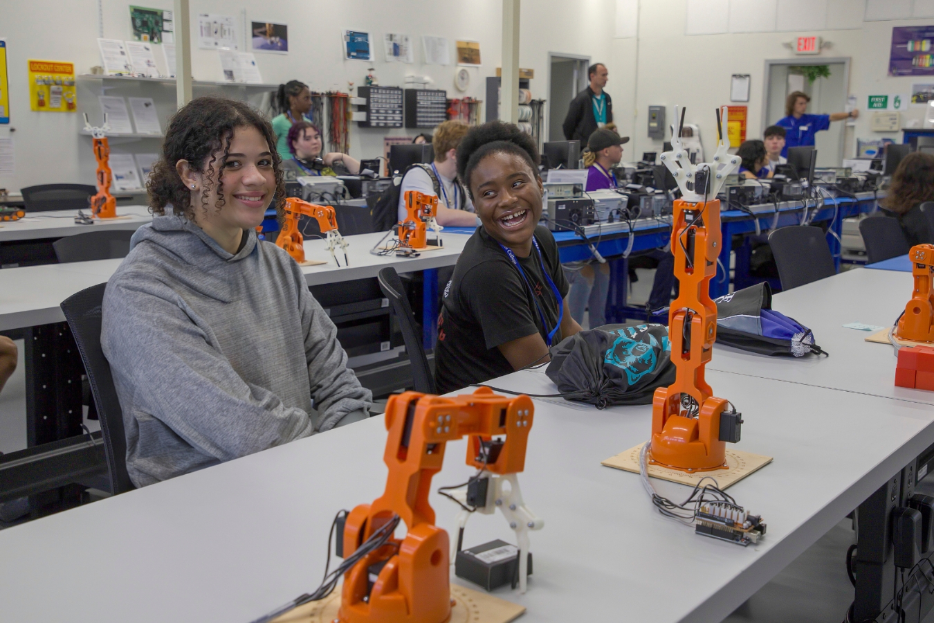 Two female students actively participating in hands-on robotics learning and practice in our state-of-the-art robotics lab.