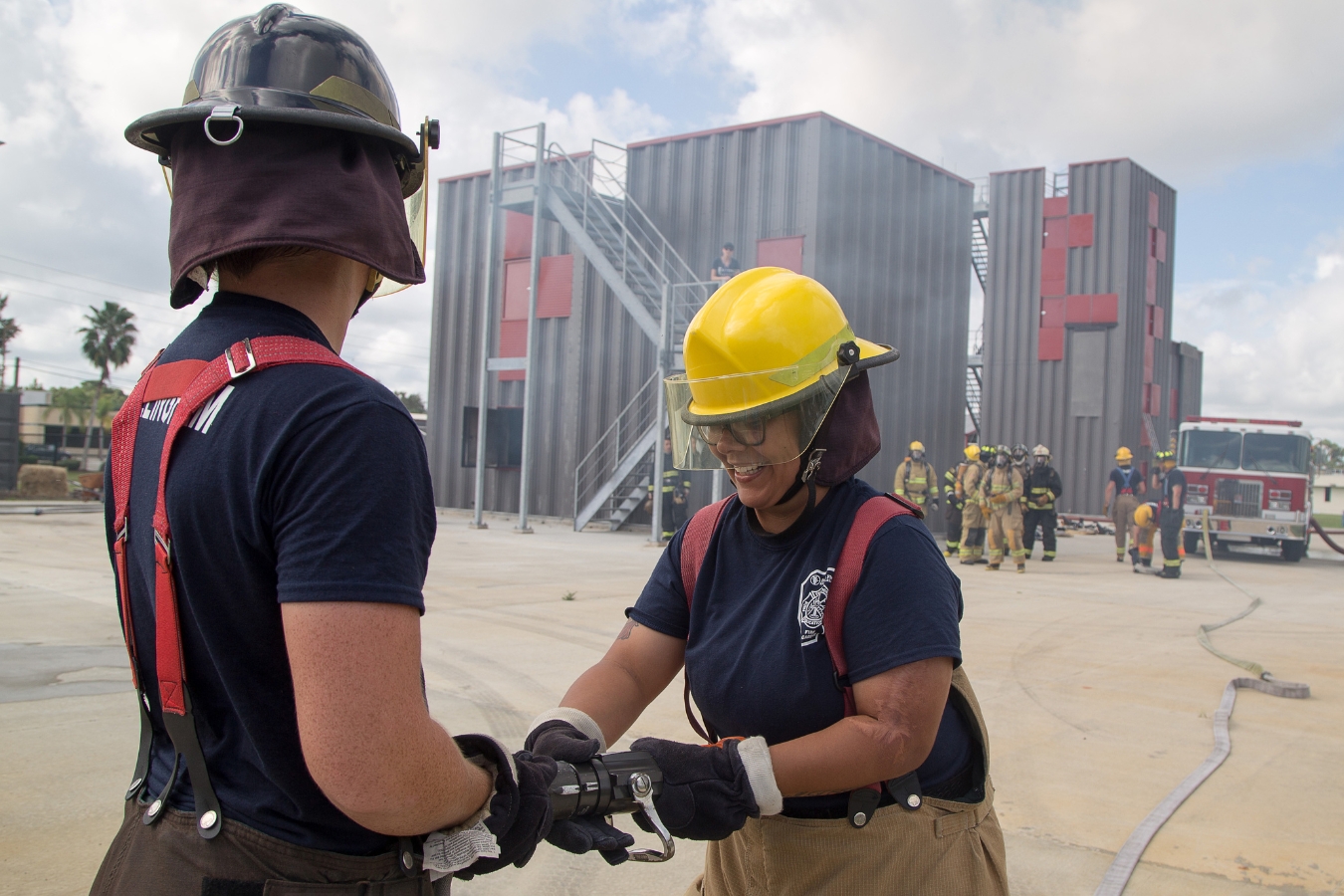 Two firefighter/ fire science students participating in a hands-on exercise at EFSC's fire science academy training facility