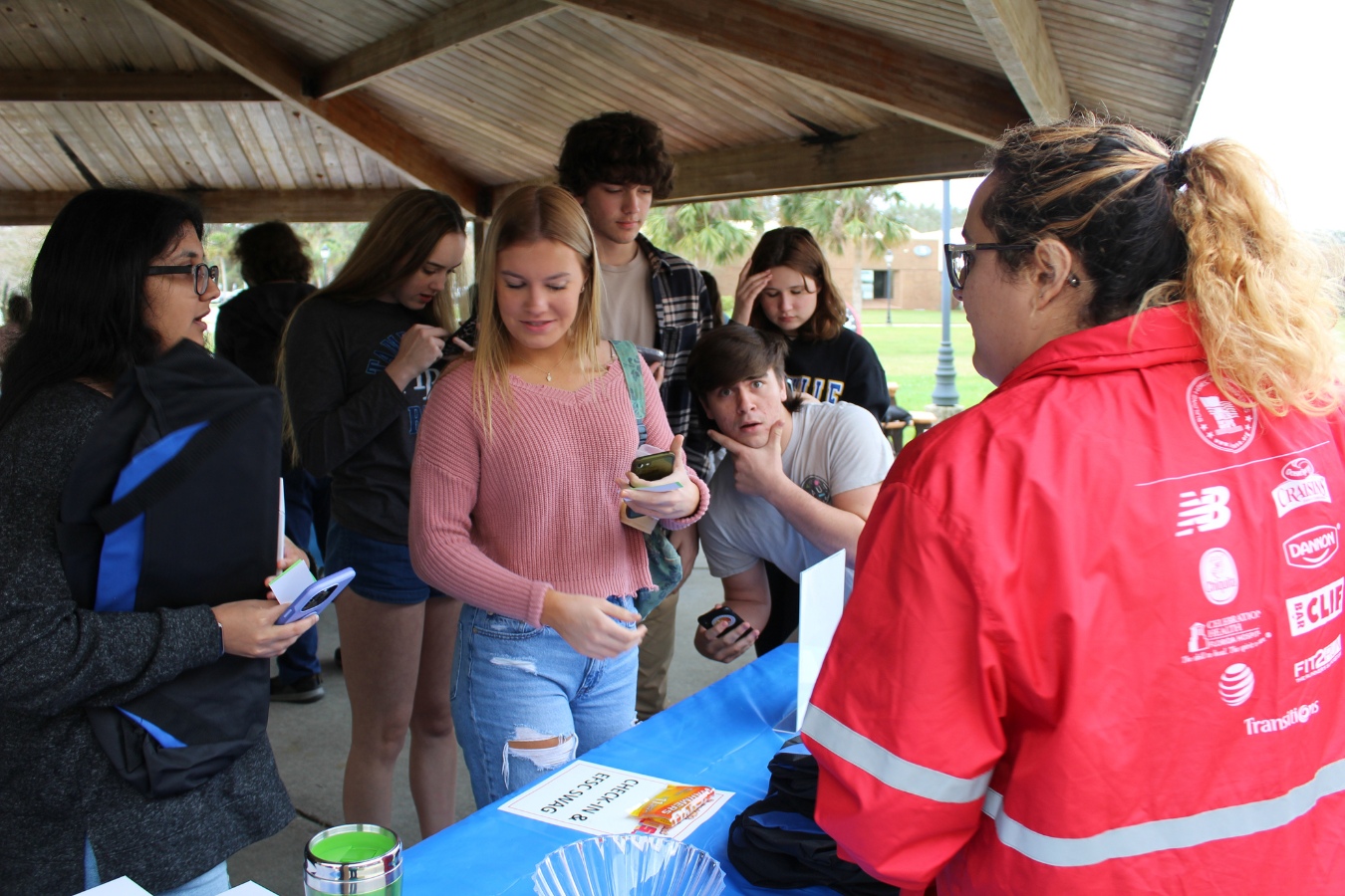 Students lined up at a booth during an event to check-in
