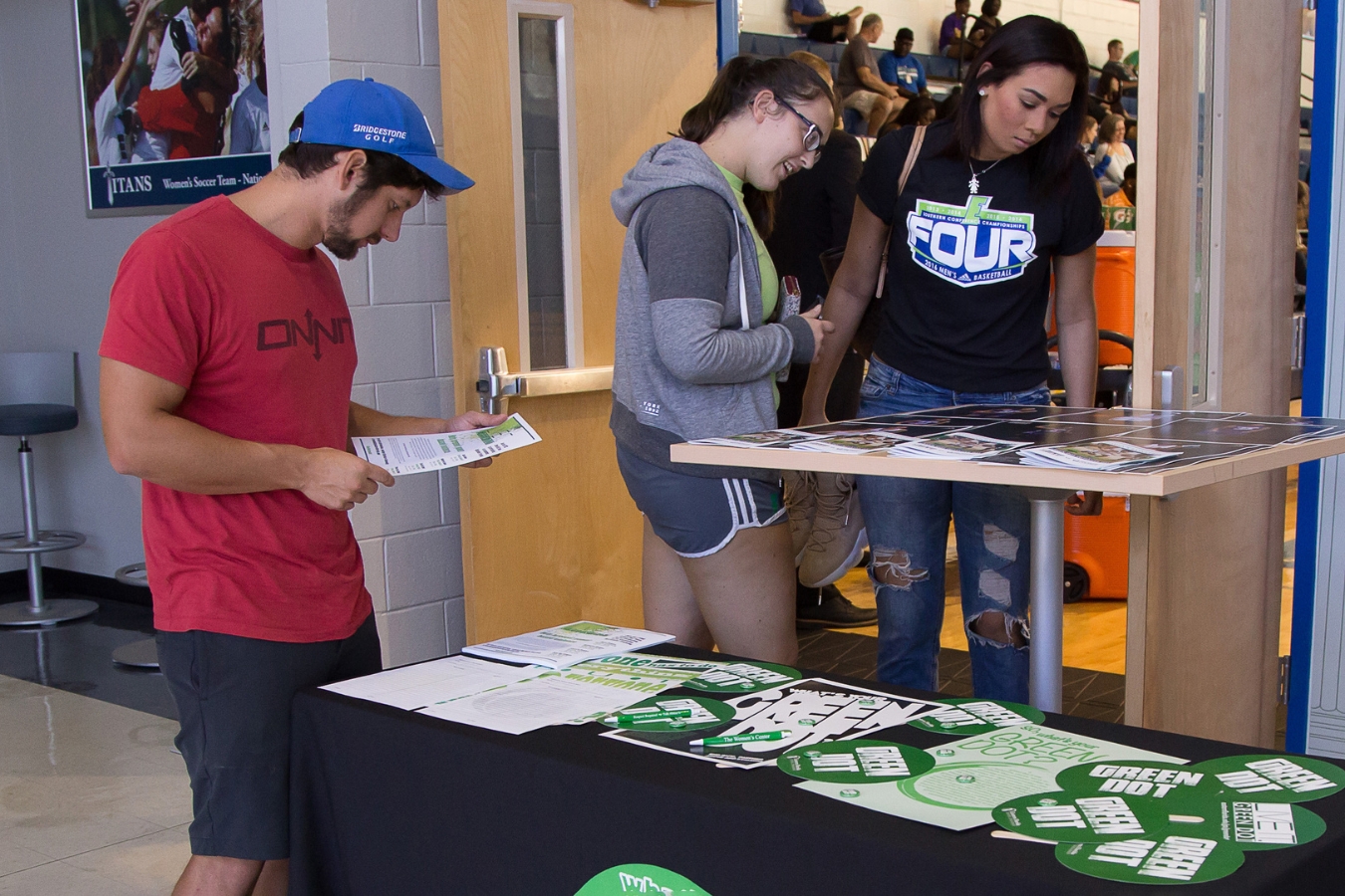 Students checking into a Green Dot event and looking at freebies and activity items