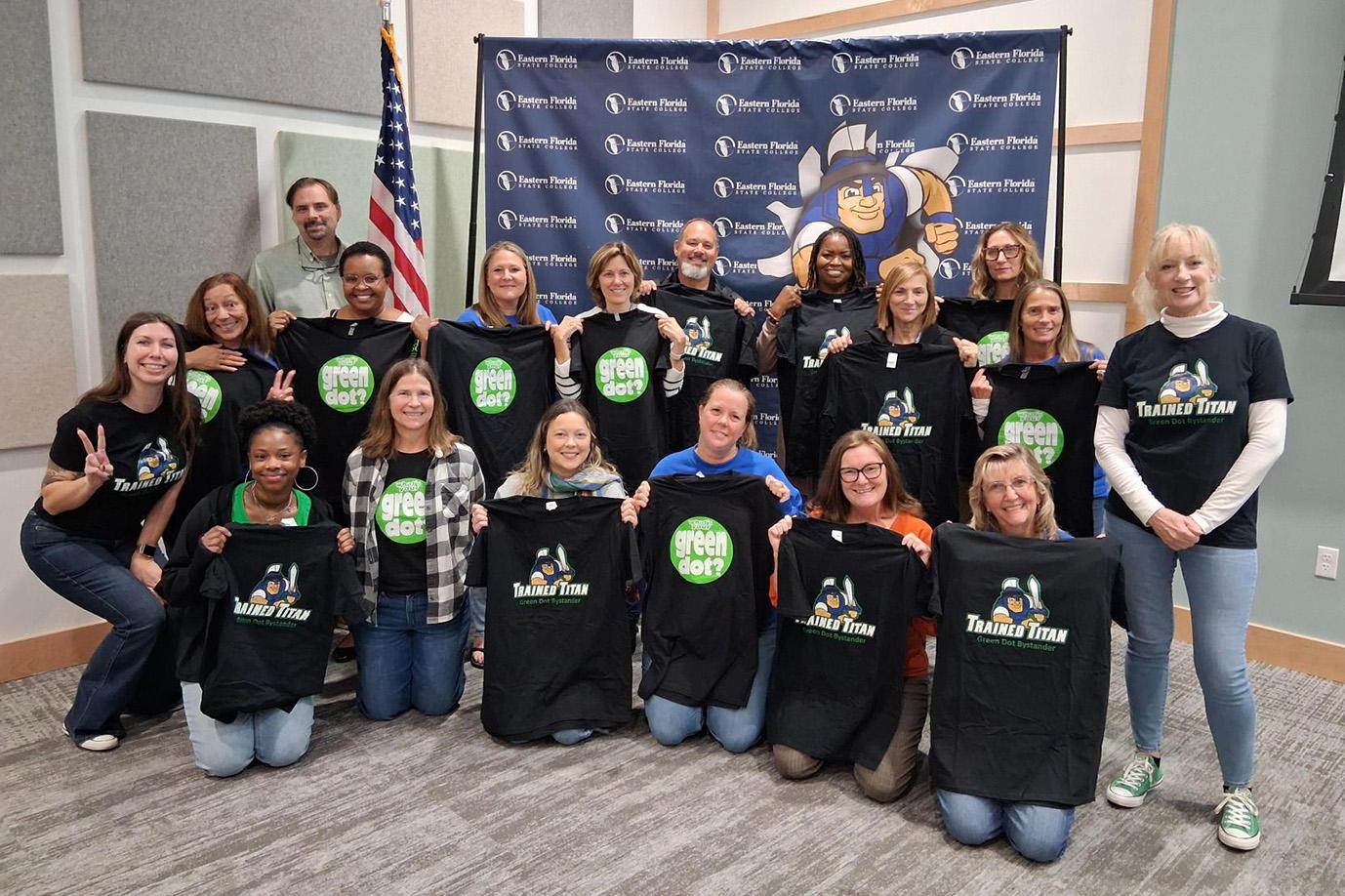 A group photo of students wearing Green Dot tees after a training session