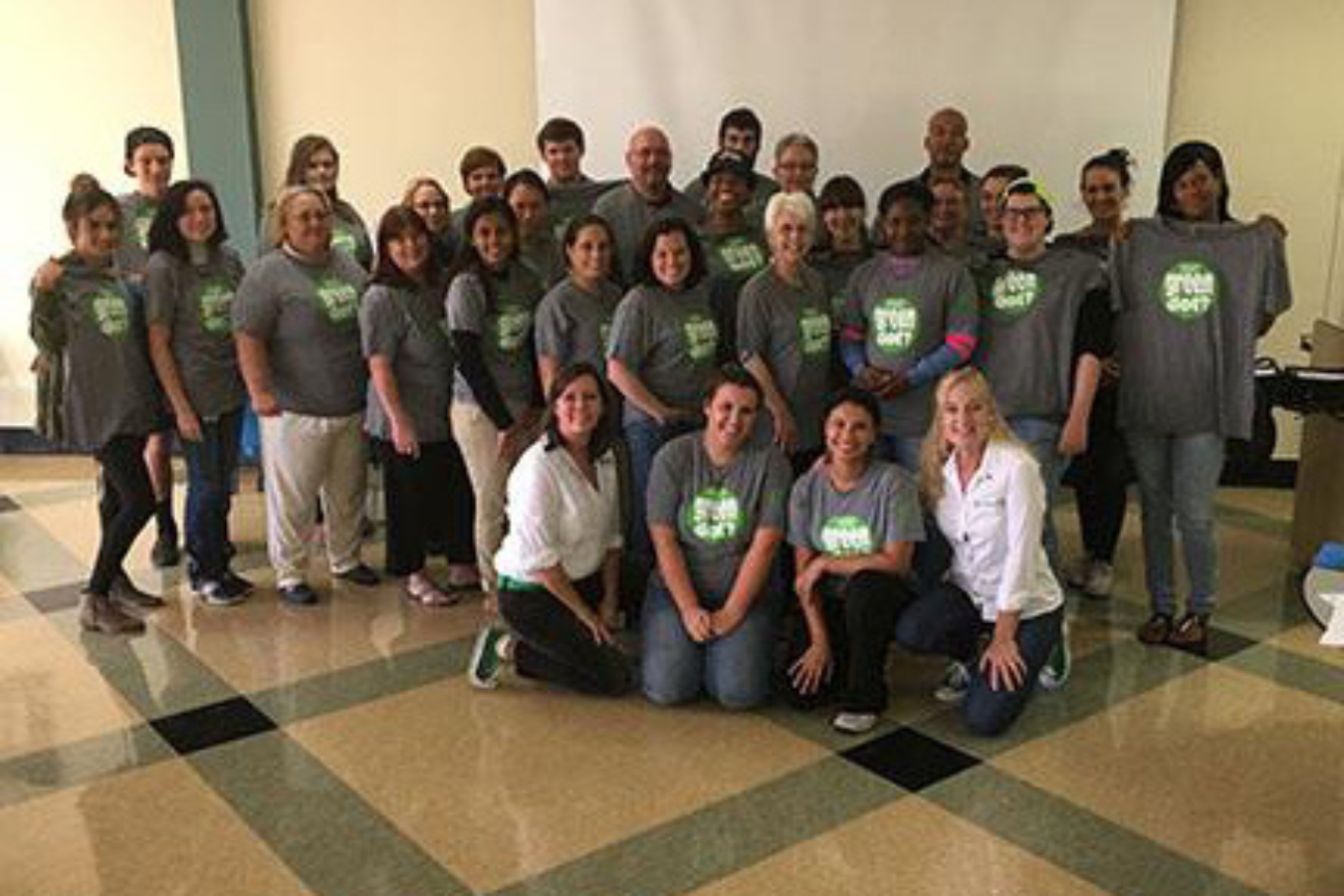 Group photo of students who attended a Green Dot workshop wearing their new Green Dot tees