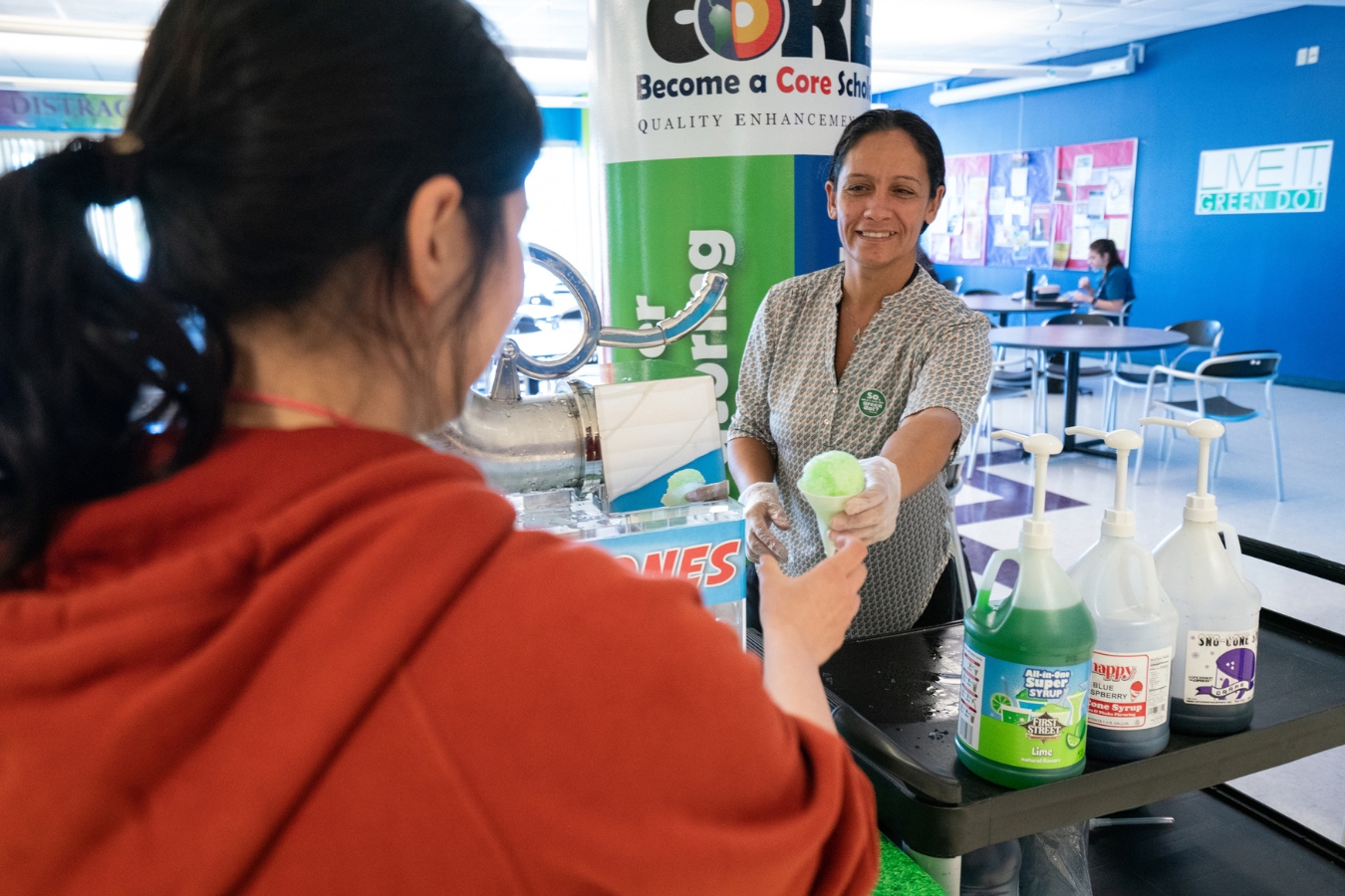 A female student grabbing a snow cone at a Green Dot campus event