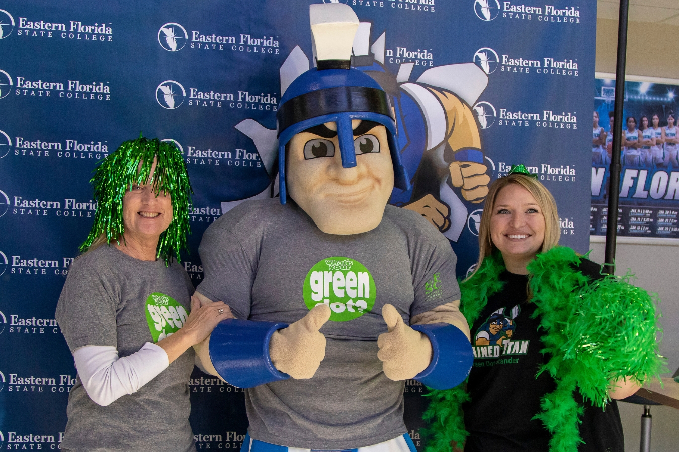 Dr. Barbara Kennedy and Mr. Titan posing for a photo in Green Dot tee shirts with another person