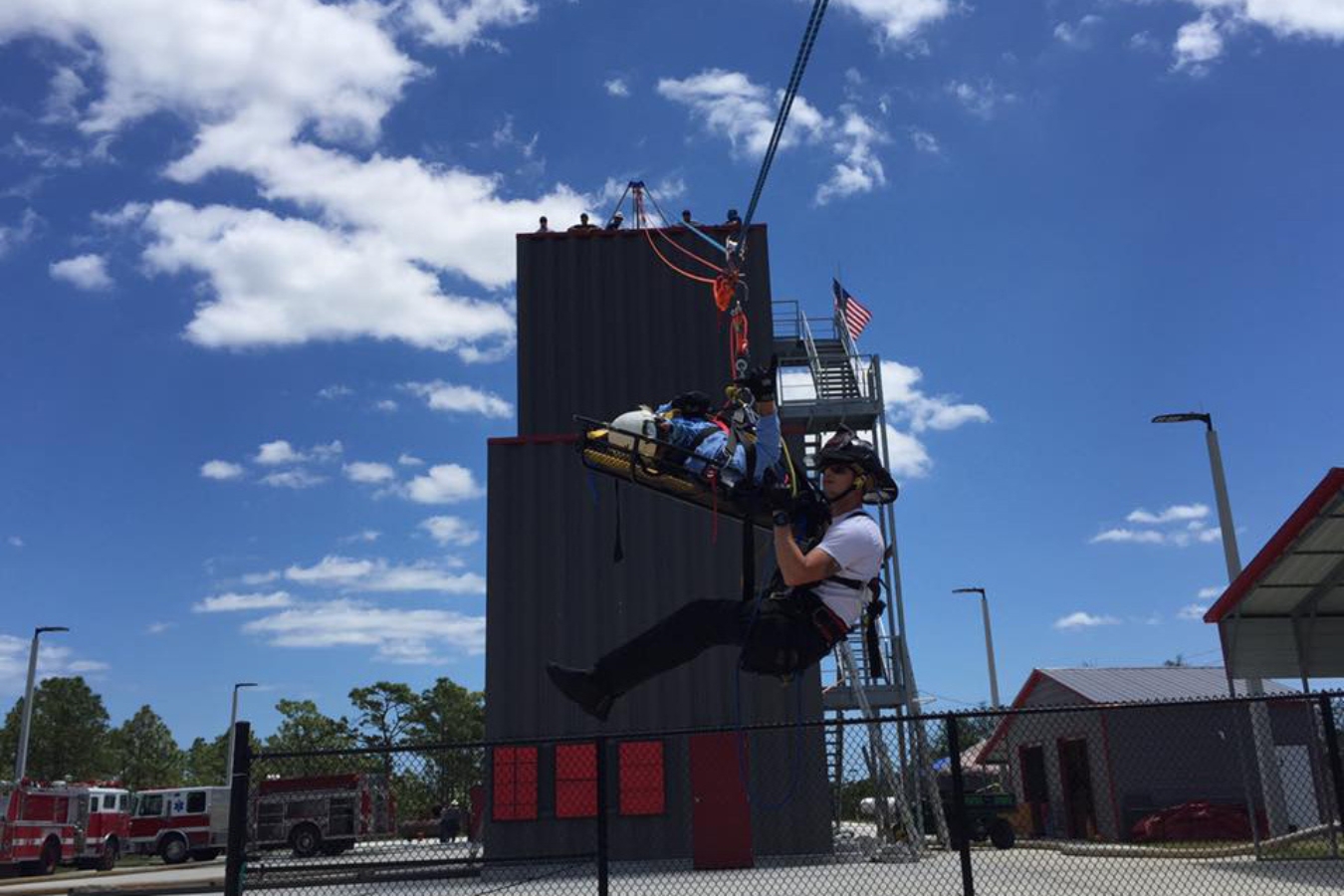 Practical exercise at Palm Bay's fire academy: Student performing rappelling while simulating a rescue