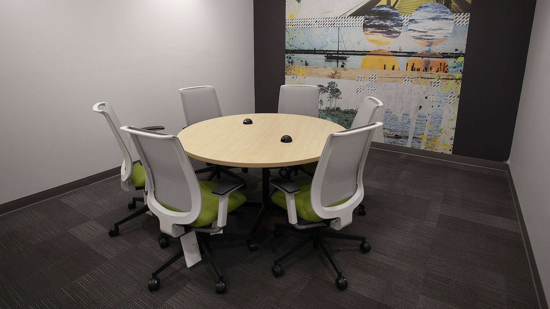 A meeting area with a round table and five chairs