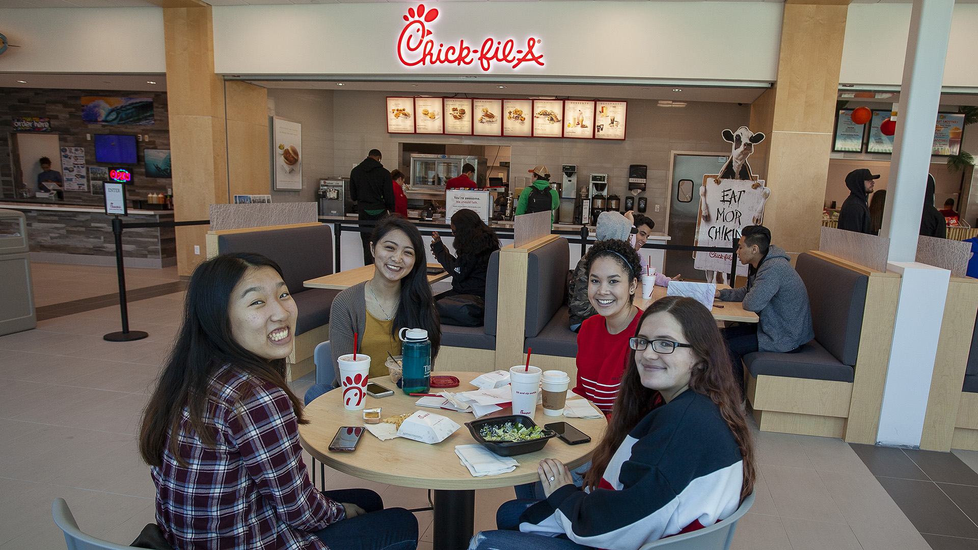 students posed for a photo eating lunch in the food court