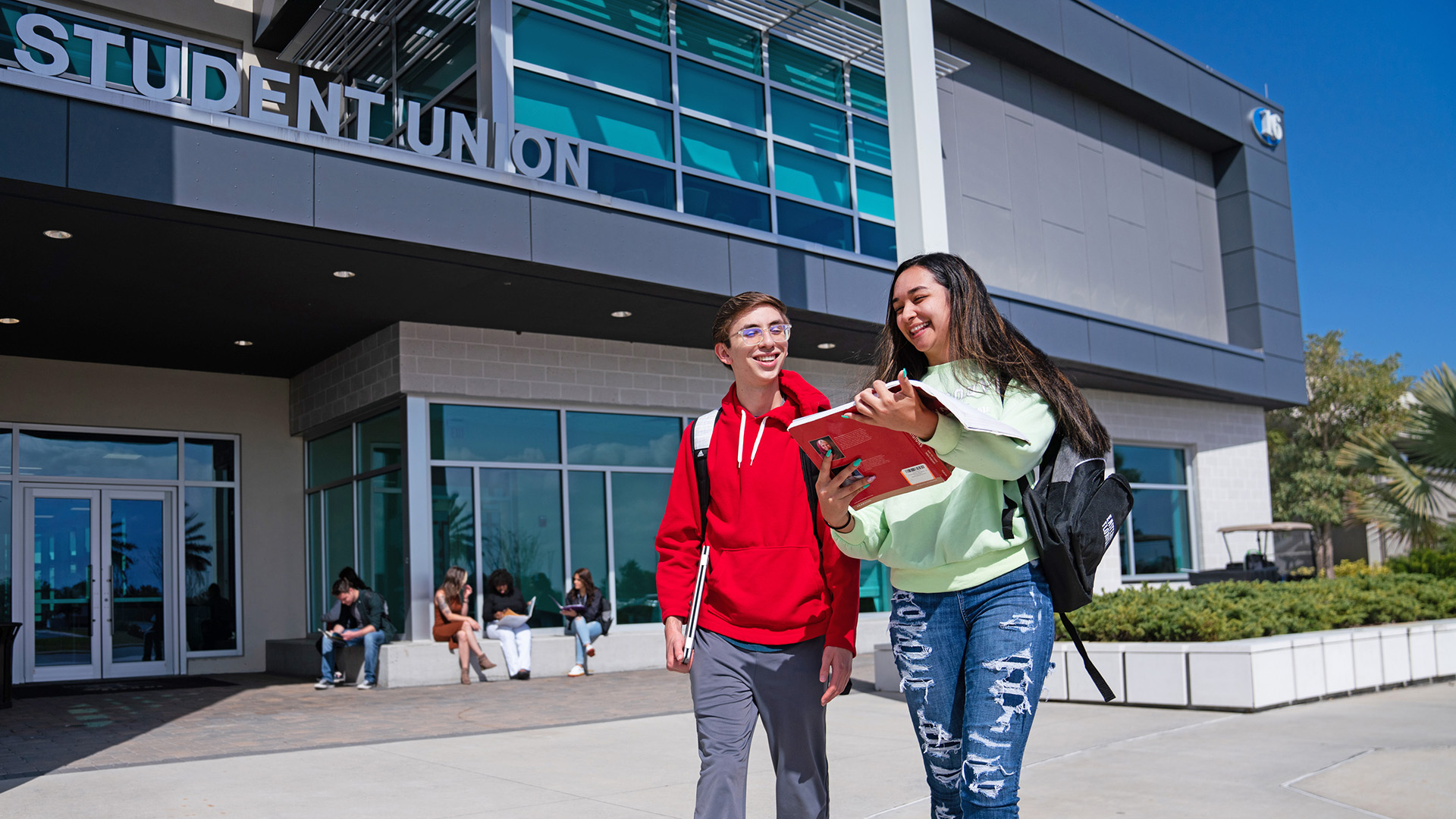 Two students walking in front of the student union