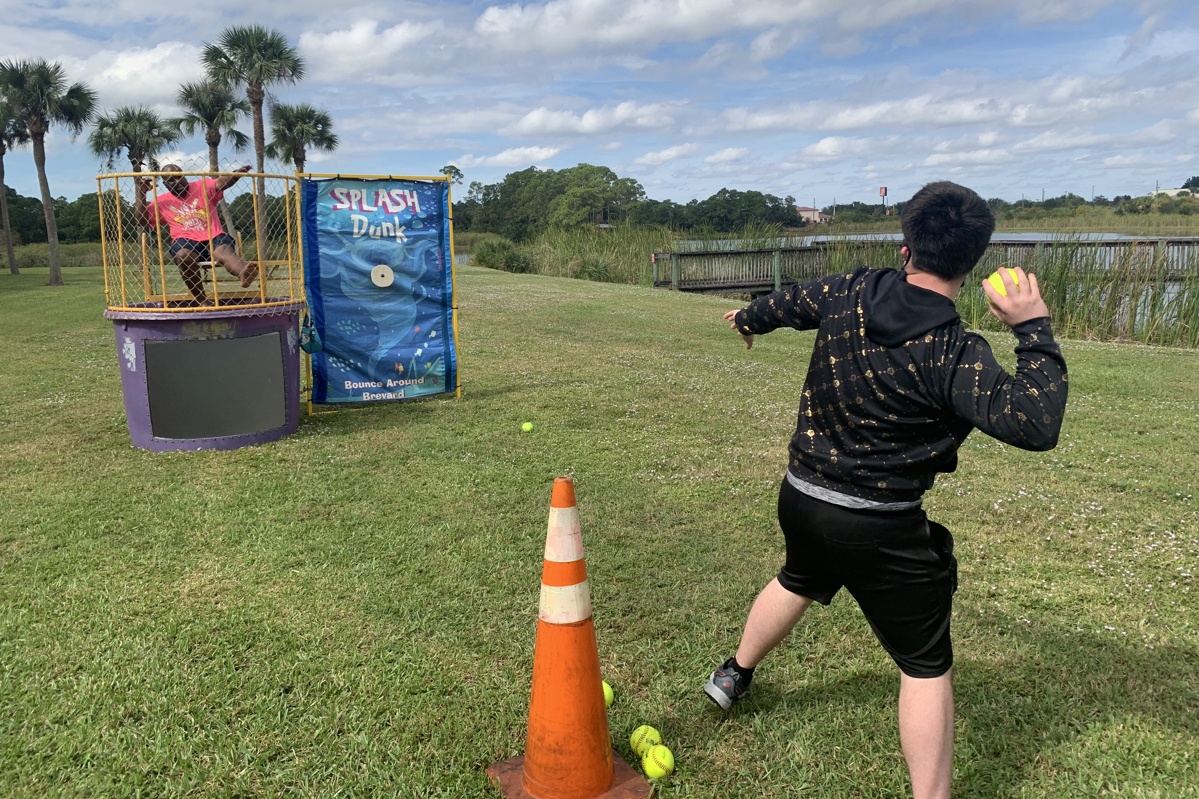 Faculty and Staff love getting involved in student events, this image features a staff member in a dunk tank as a student prepare to throw their ball