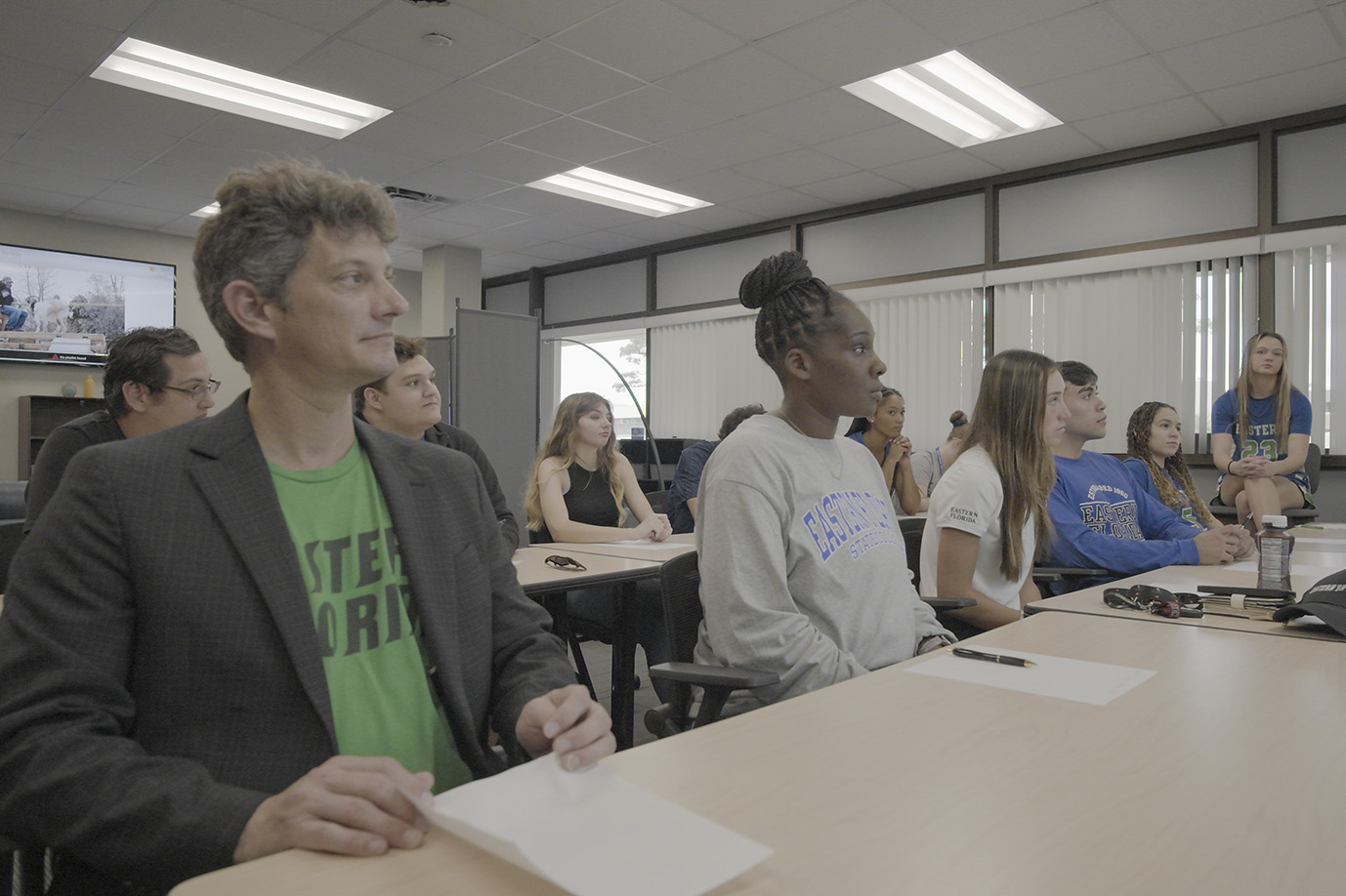 A group of students sitting in class looking forward.