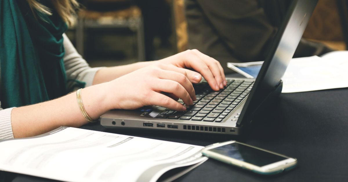 student hands at computer