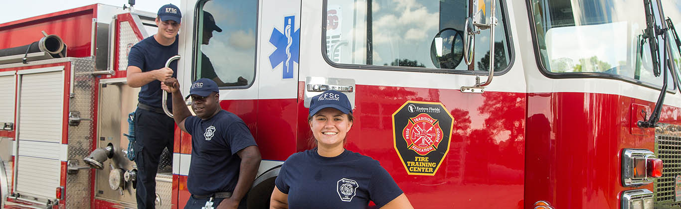 Fire science students in front of a fire truck