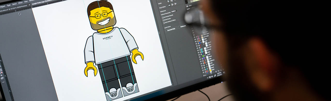 Student working on an image of a Lego person in Photoshop.