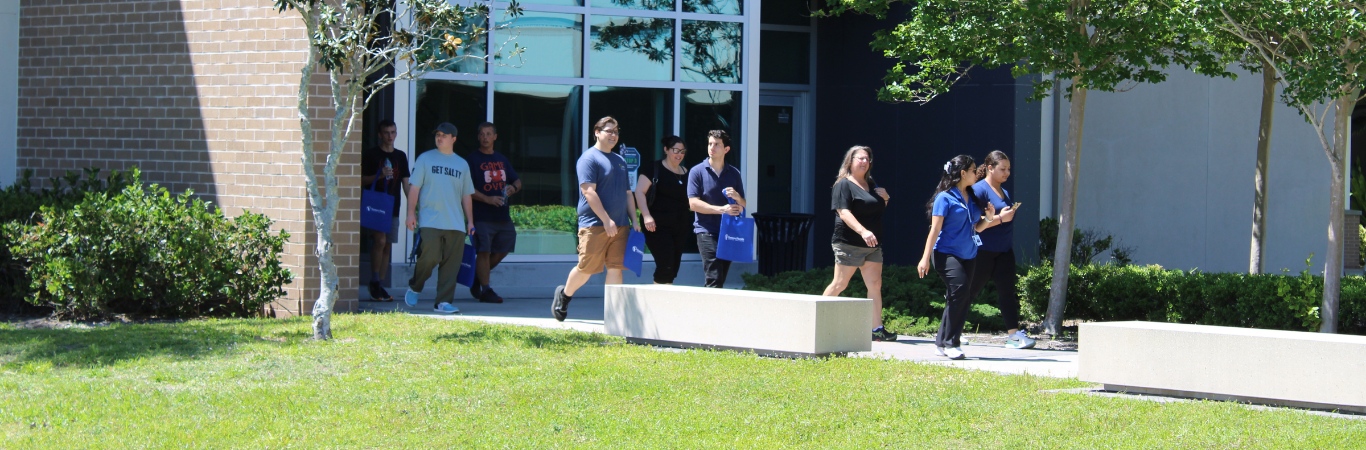 A group of prospective students walk in a row taking a tour