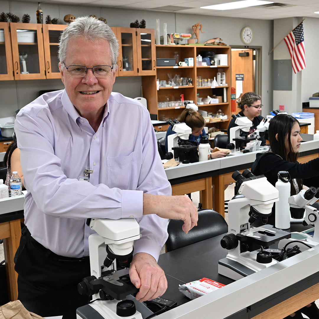 Man standing at microscope