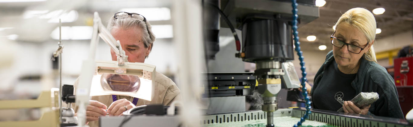 A man and a woman working with manufacturing machinery.