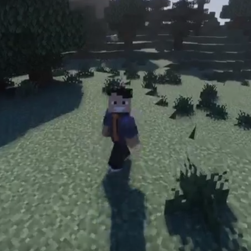 Ryan Radcliffe smiles in a selfie next to the Minecraft version of himself