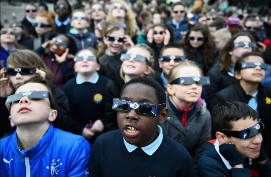 Children wearing eclipse viewing glasses