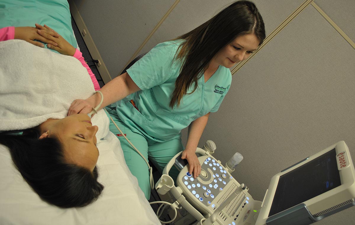 Sonography student performing ultrasound