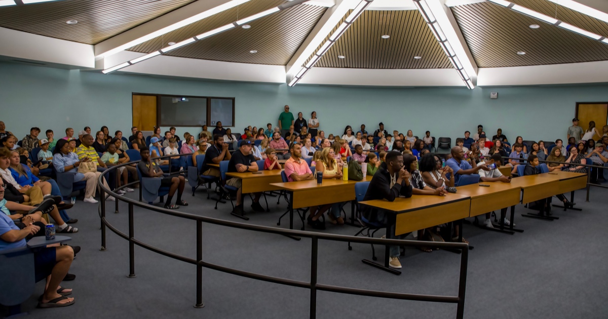 Golf Camp participants, family members, and volunteers gather at awards ceremony