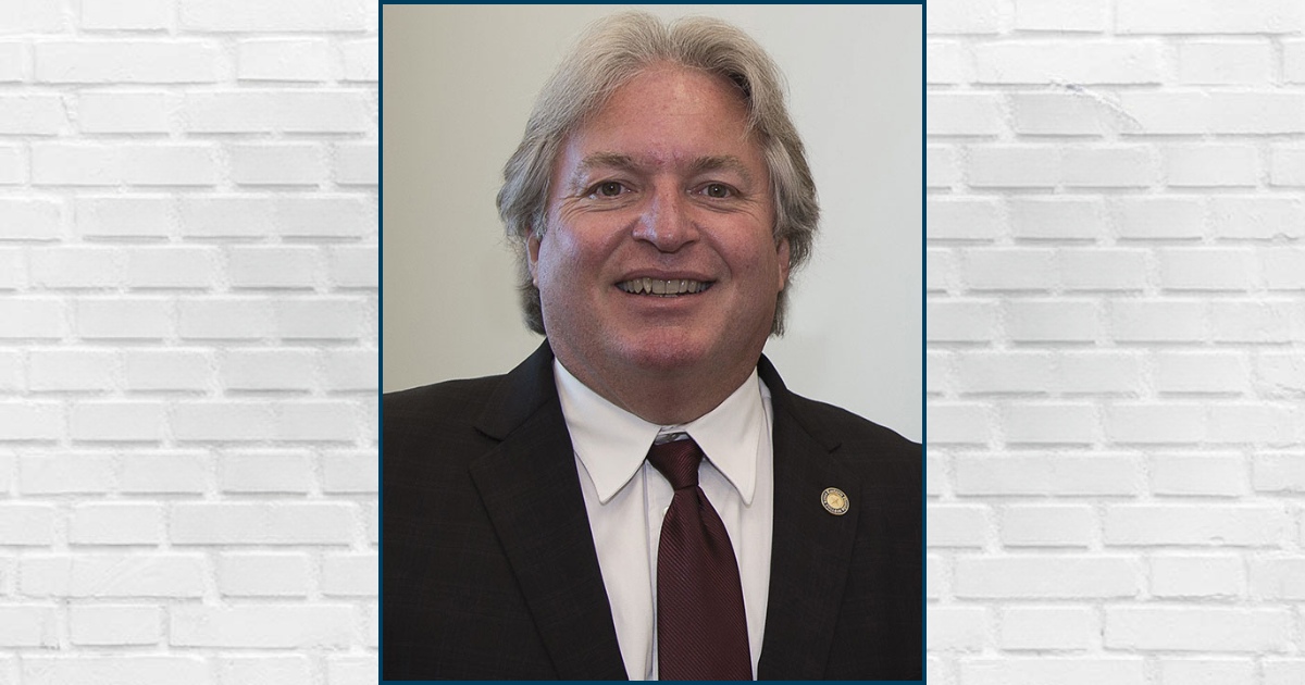 An image of Ronald Howse in front of a brick wall
