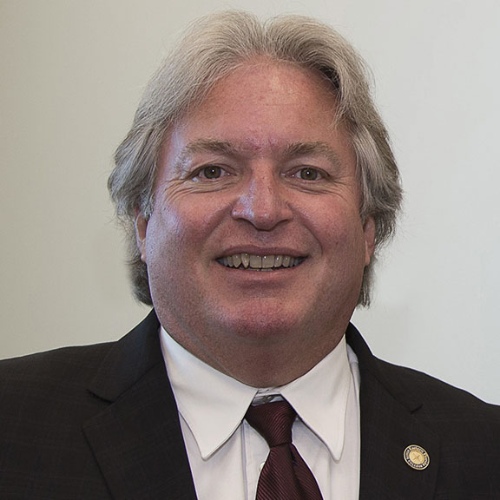 An image of Ronald Howse in front of a brick wall