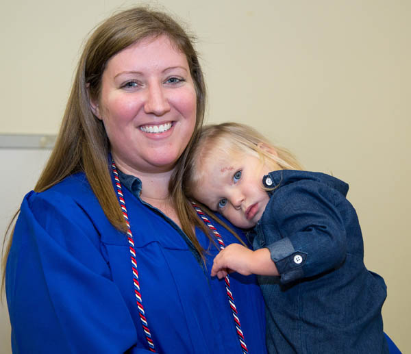 EFSC graduate holding daughter