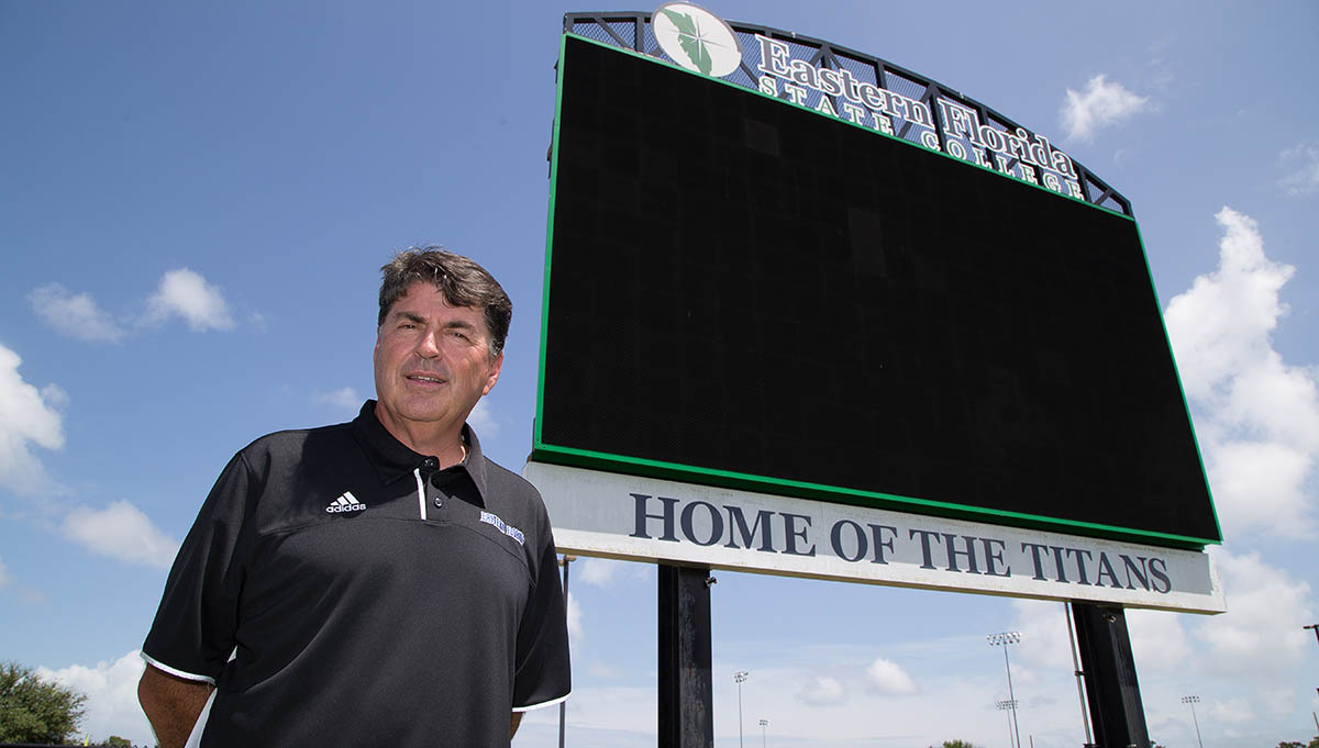 man in front of EFSC Titans Scorebard