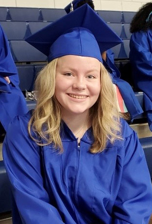 female graduate in blue cap and gown