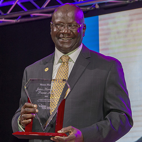 Trustee Harvin receiving the Community Leadership award on stage.