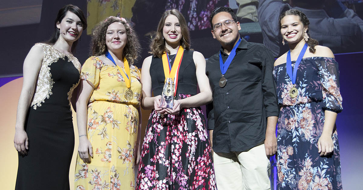 award recipients in evening wear, four women and one man